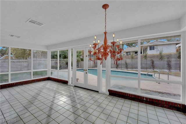 unfurnished sunroom with a chandelier and a wealth of natural light