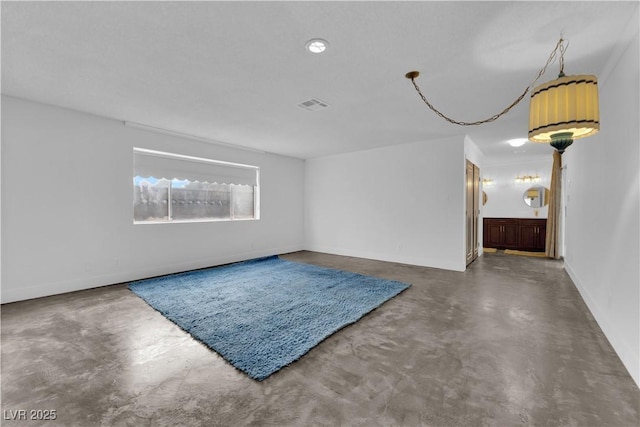 unfurnished room featuring concrete floors