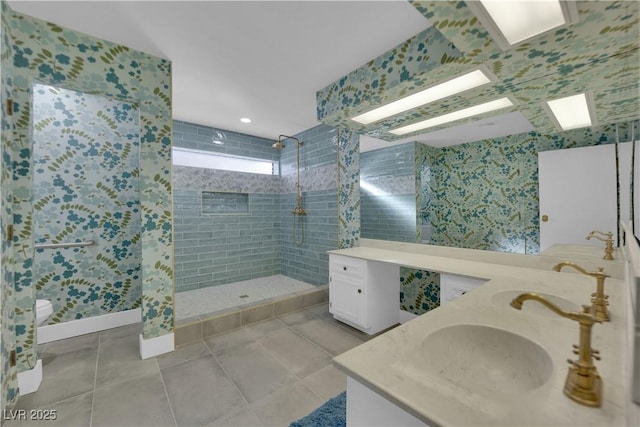 bathroom featuring tiled shower, vanity, toilet, and tile patterned flooring