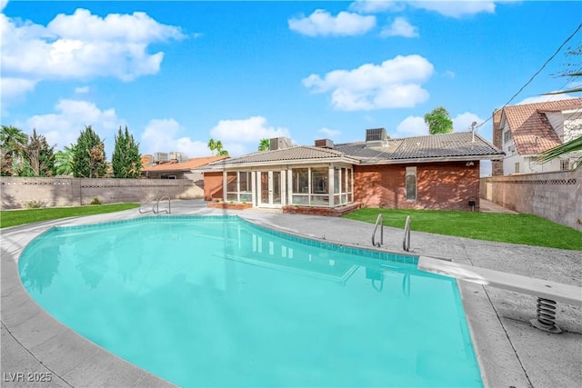 view of swimming pool with a diving board and a patio