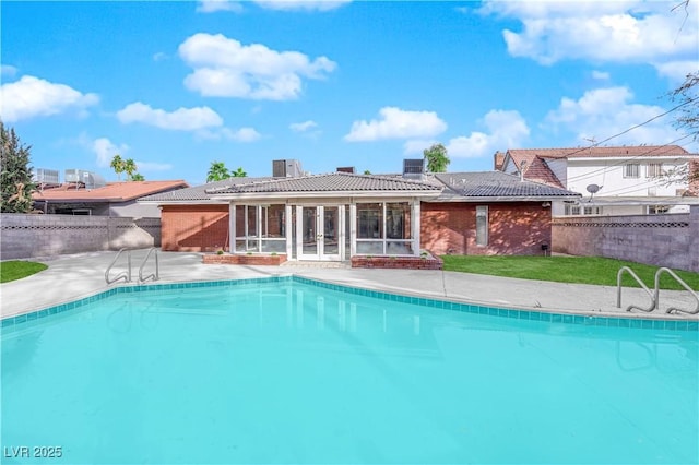 view of swimming pool featuring french doors