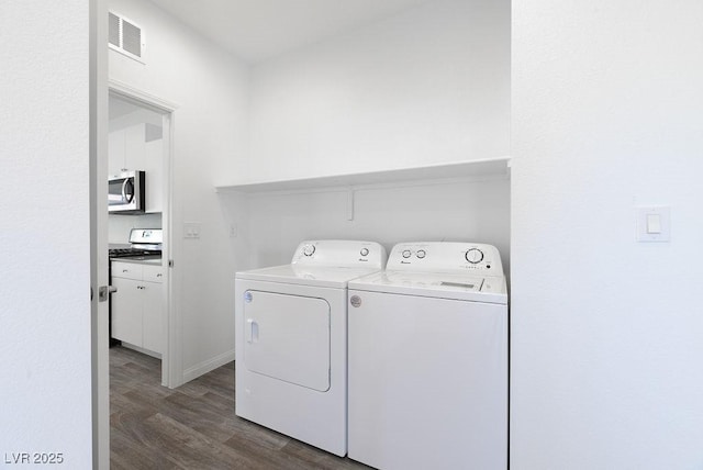 laundry area featuring dark hardwood / wood-style floors and independent washer and dryer