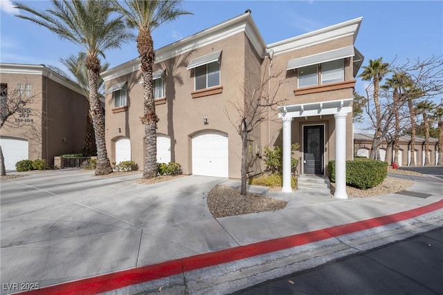 townhome / multi-family property with stucco siding and an attached garage