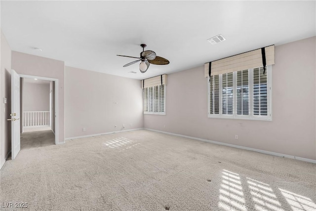 carpeted empty room featuring ceiling fan