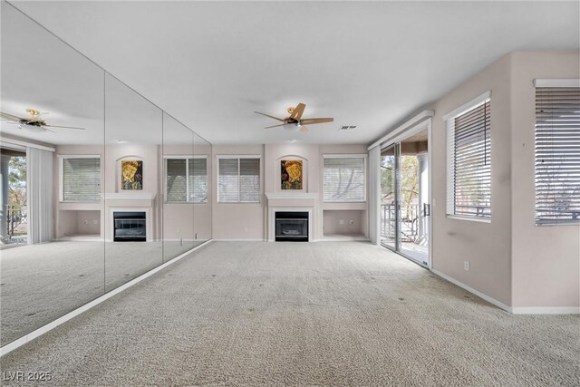 unfurnished living room with carpet floors and ceiling fan