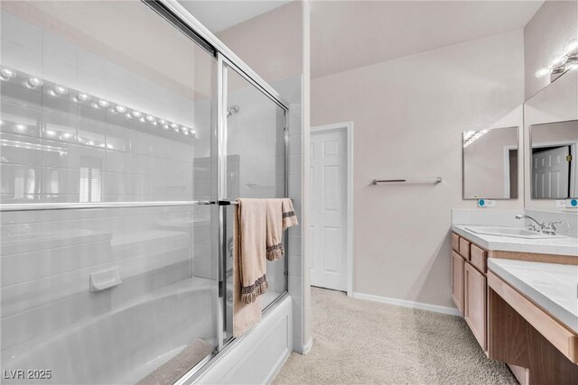 bathroom featuring vanity and shower / bath combination with glass door