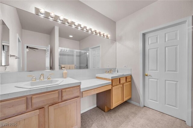 bathroom with walk in shower, ceiling fan, and vanity