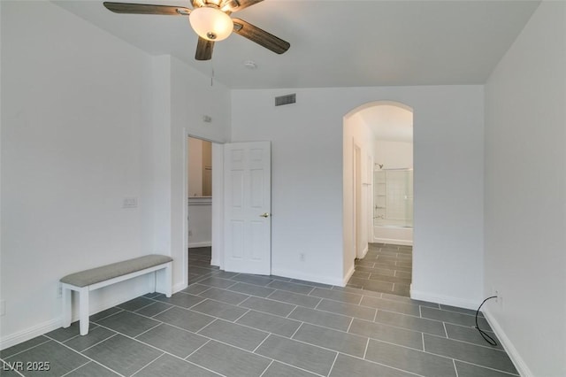 tiled spare room with ceiling fan and vaulted ceiling