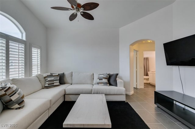 tiled living room with ceiling fan