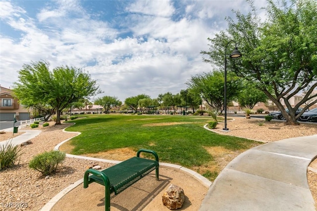 view of home's community with a yard