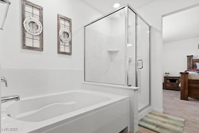 bathroom with shower with separate bathtub