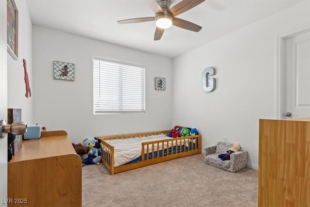 bedroom featuring ceiling fan and light carpet