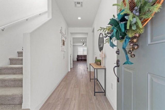 corridor with light hardwood / wood-style flooring