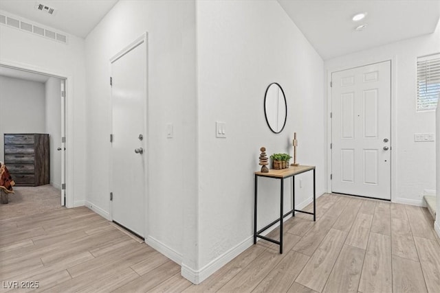 foyer entrance with light hardwood / wood-style flooring