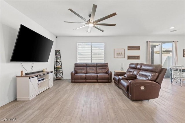 living room with ceiling fan and light wood-type flooring