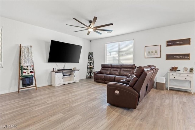 living room with ceiling fan and light hardwood / wood-style flooring