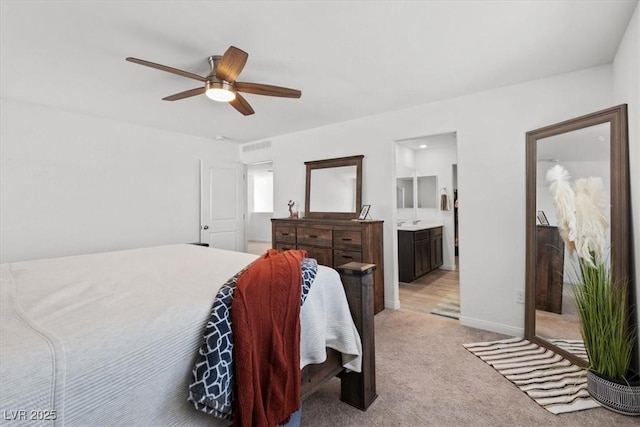 carpeted bedroom with ceiling fan and ensuite bathroom