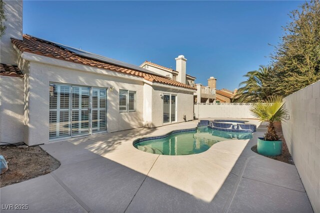 view of pool featuring an in ground hot tub and a patio