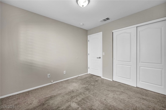 unfurnished bedroom with a closet and carpet floors