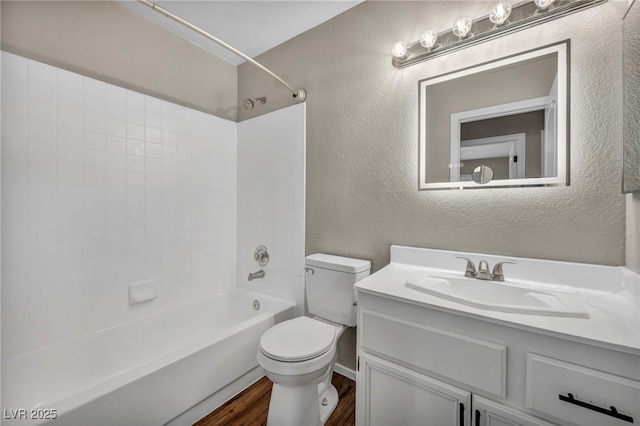 full bathroom with toilet, vanity, hardwood / wood-style floors, and shower / bath combination