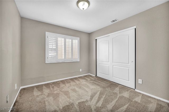 unfurnished bedroom featuring carpet floors and a closet