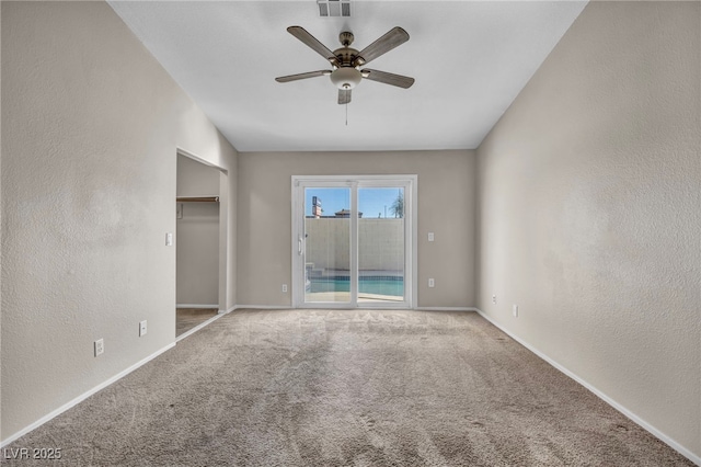 unfurnished room featuring ceiling fan and carpet floors