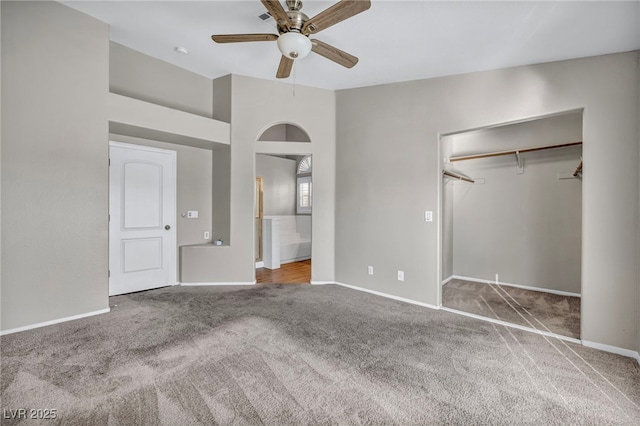 unfurnished bedroom with ceiling fan, a closet, and carpet