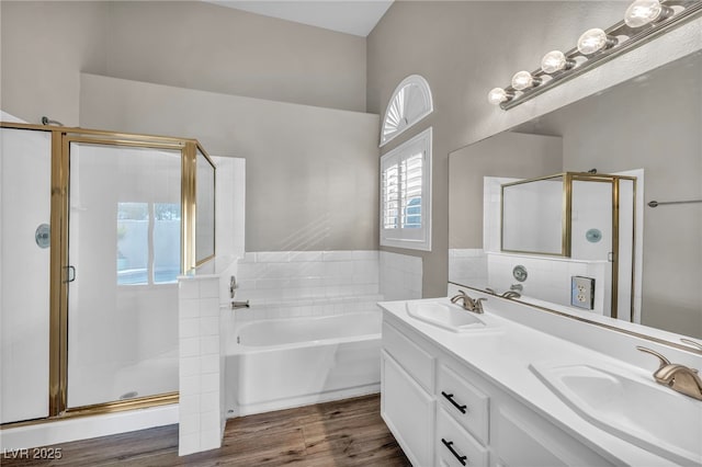 bathroom featuring vanity, hardwood / wood-style floors, and plus walk in shower