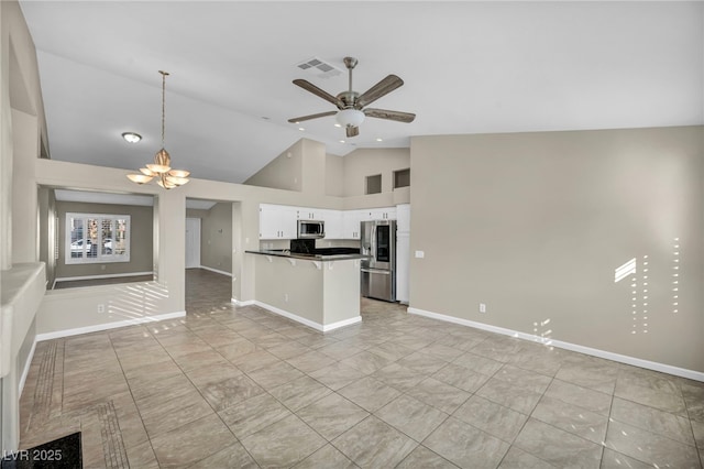 kitchen with kitchen peninsula, hanging light fixtures, stainless steel appliances, white cabinetry, and ceiling fan with notable chandelier