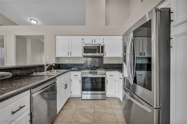 kitchen featuring sink, white cabinets, light tile patterned floors, and appliances with stainless steel finishes