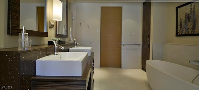 bathroom featuring vanity and a tub