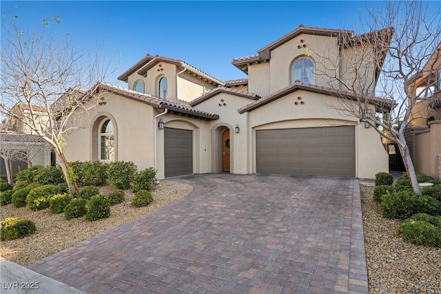 mediterranean / spanish house with a garage