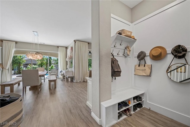 mudroom featuring light hardwood / wood-style floors and a notable chandelier