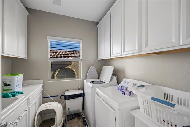 washroom with cabinets and independent washer and dryer