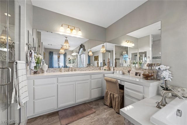 bathroom with a shower with door and vanity