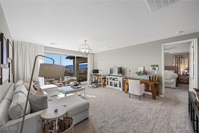 living room featuring a notable chandelier and carpet