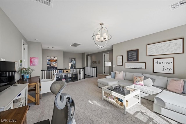 carpeted living room featuring a chandelier