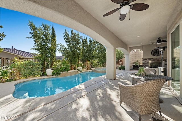 view of swimming pool with an outdoor kitchen, a patio, ceiling fan, and an in ground hot tub