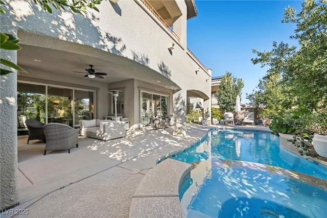 view of pool with ceiling fan, outdoor lounge area, and a patio