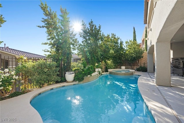 view of pool with a patio area and an in ground hot tub