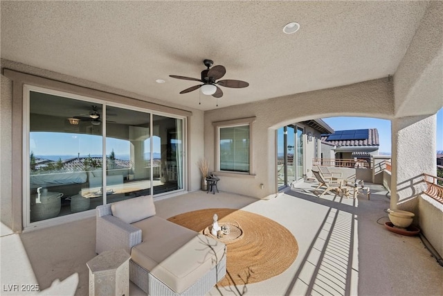 view of patio with a balcony and ceiling fan