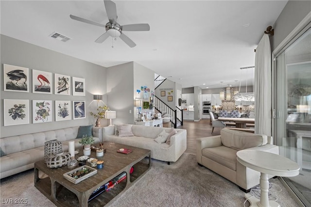 living room featuring ceiling fan and hardwood / wood-style floors