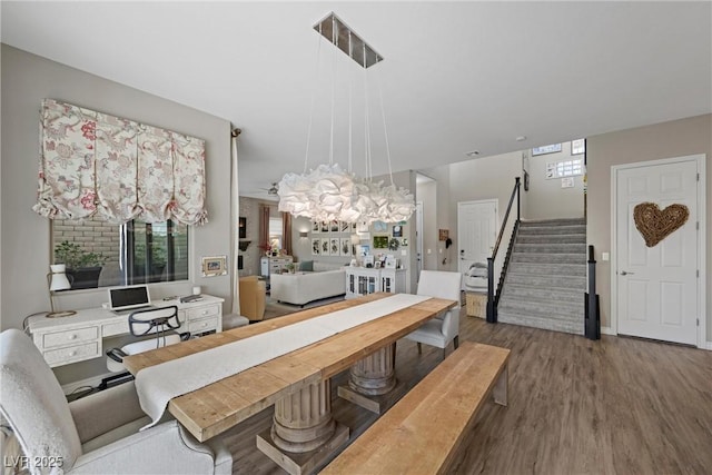 dining space with a chandelier and wood-type flooring