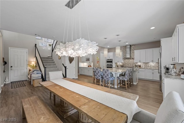 dining space featuring an inviting chandelier and dark hardwood / wood-style flooring