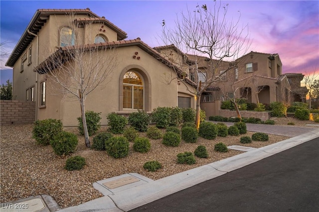 mediterranean / spanish-style home with a garage