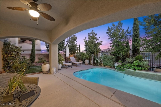 pool at dusk with ceiling fan