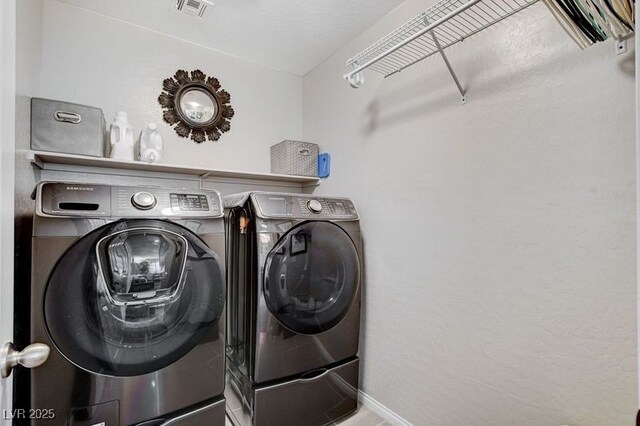 clothes washing area with separate washer and dryer