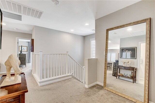 hallway with light carpet