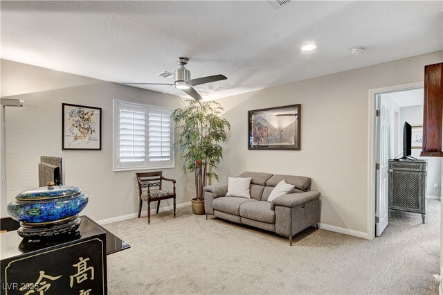 living room featuring light carpet and ceiling fan