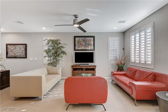 living room featuring light tile patterned flooring and ceiling fan